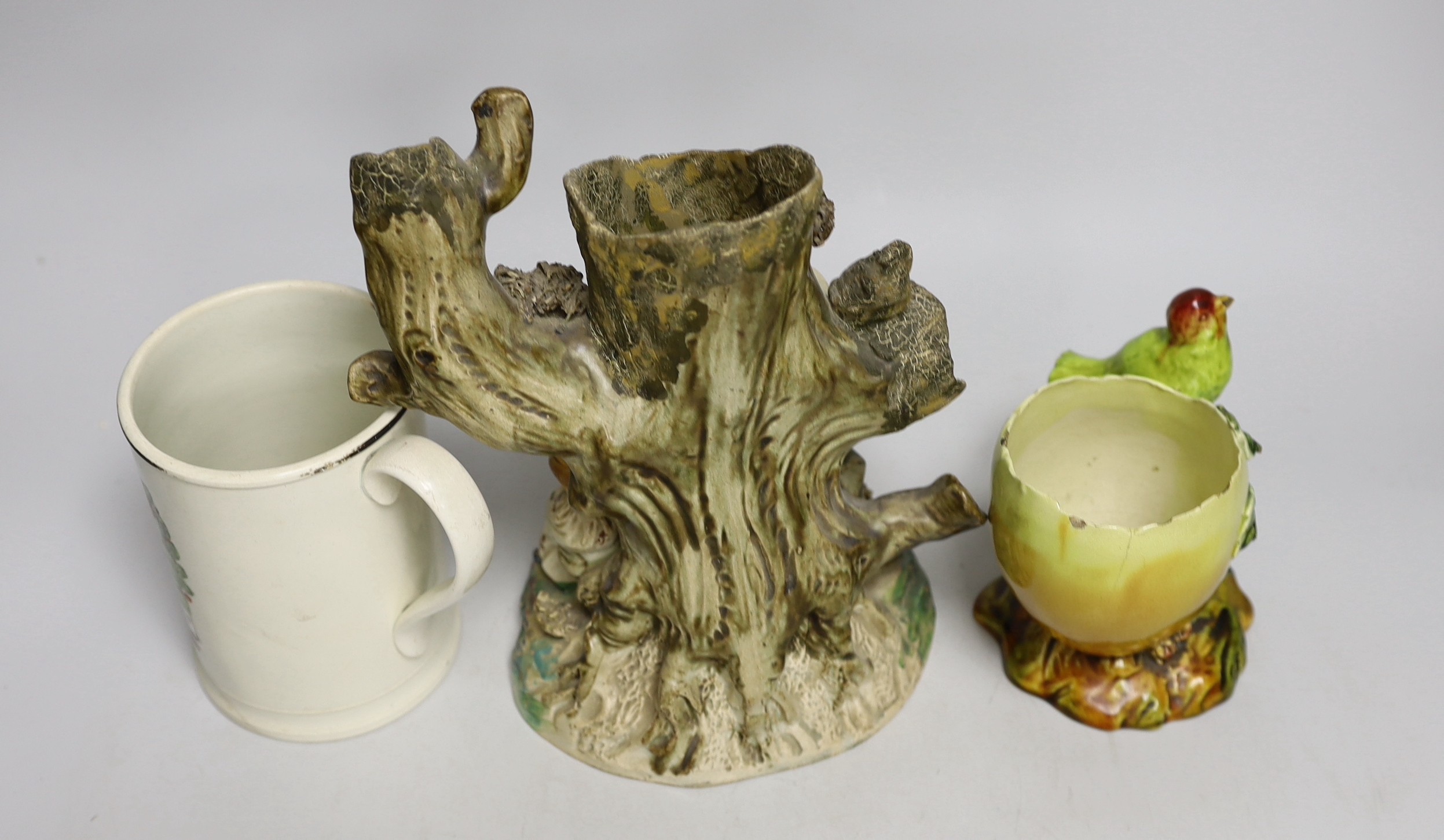 An early Staffordshire figure group, a Bretby egg shaped vase and a 19th century Iron Bridge frog tankard, figure group 24cms high